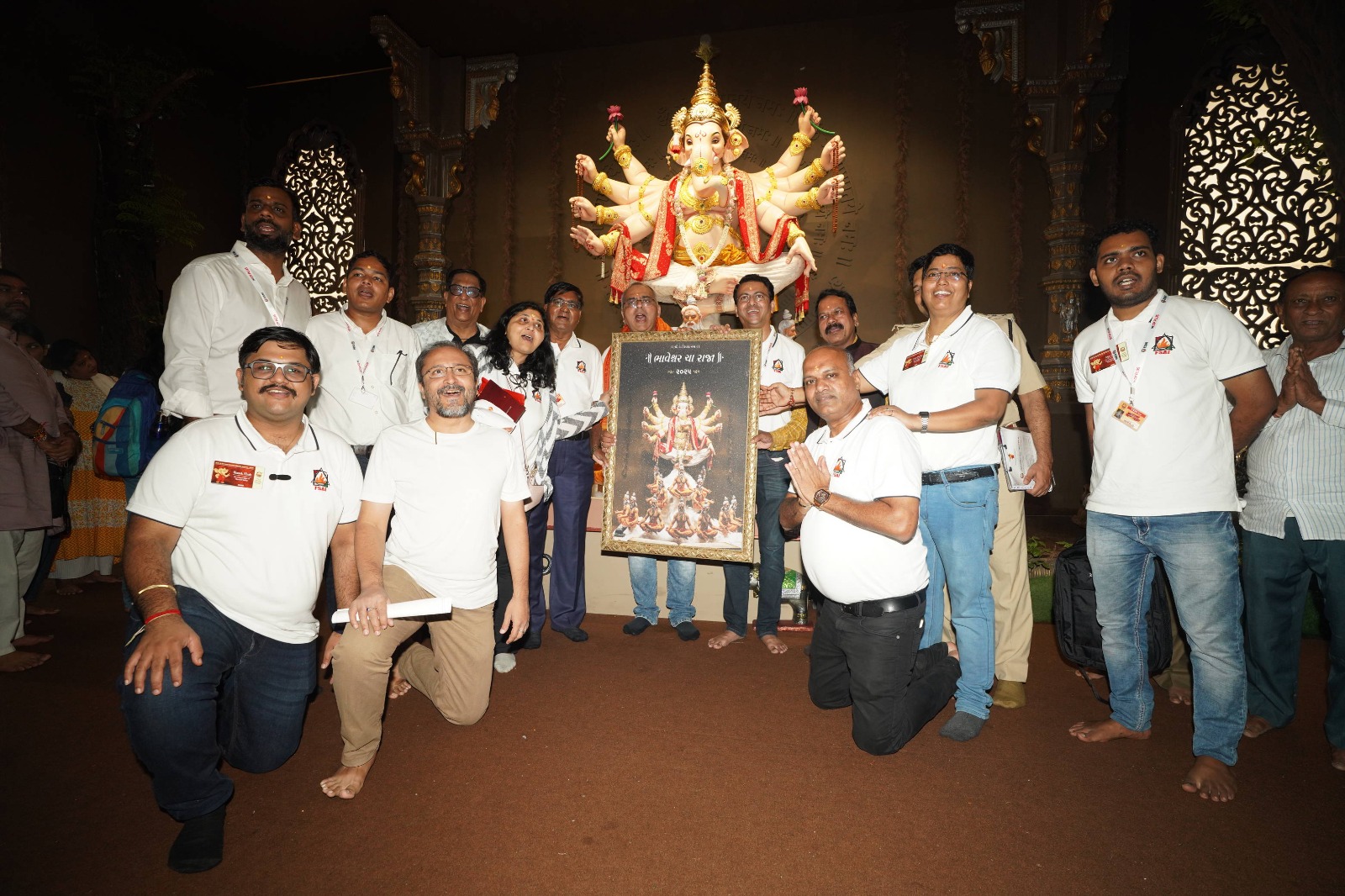 FSAI team and officials with a framed religious artwork in front of a beautifully decorated Ganesh idol