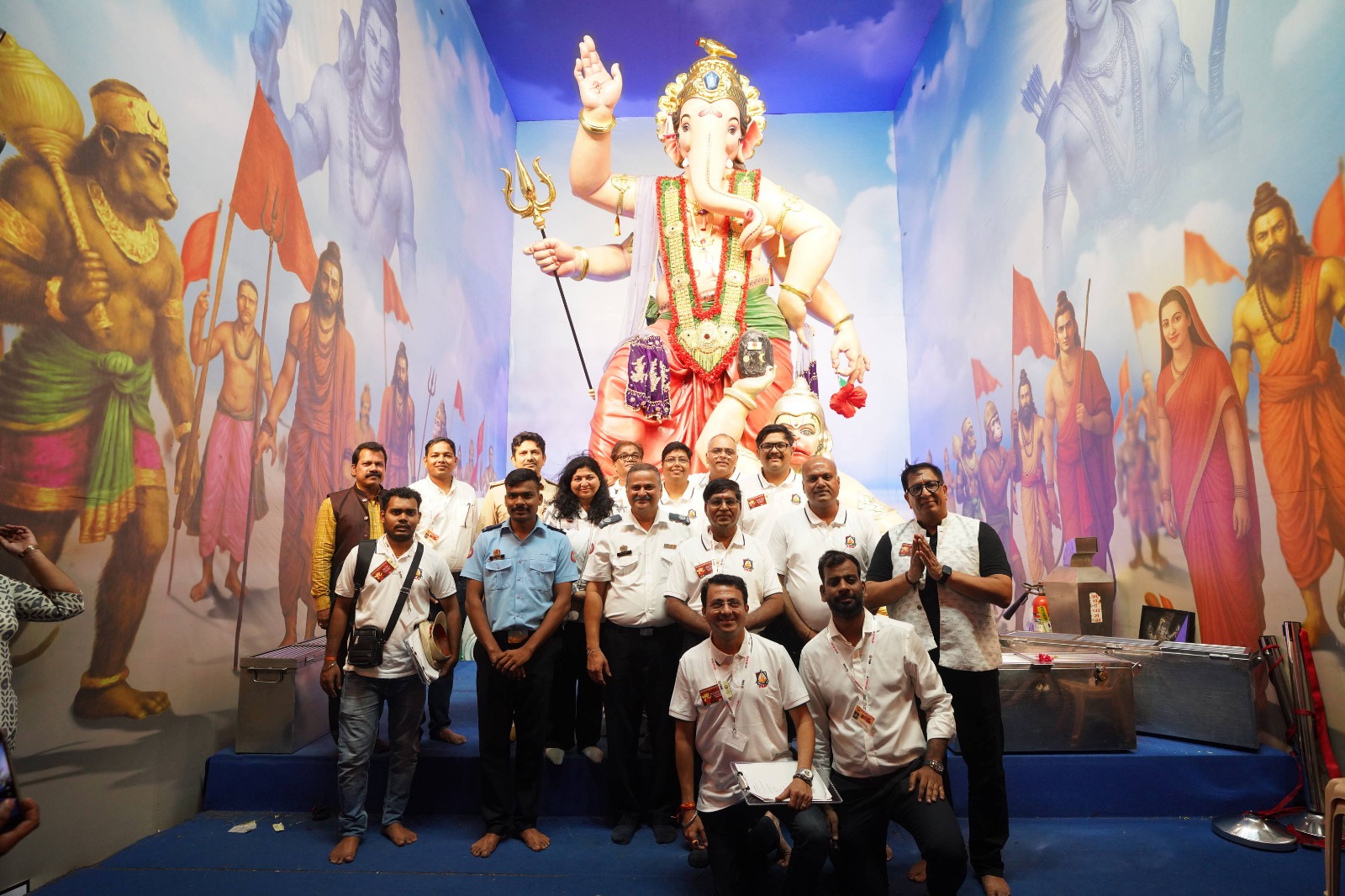Audit team and fire officials before the Ganpati idol at a mandal