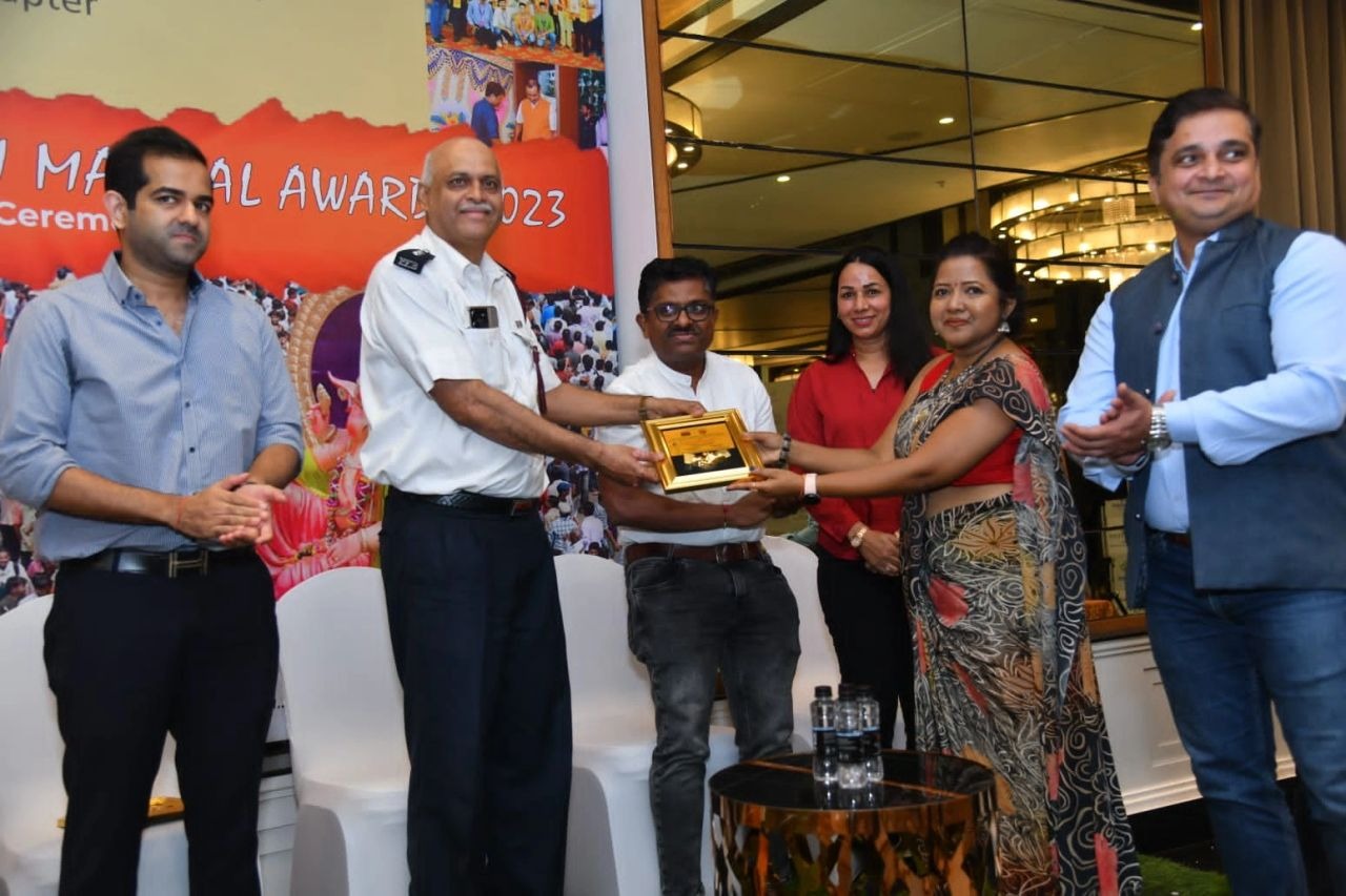 Mandal representative receiving the Safe & Secure award memento from a Fire Officer